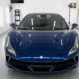 Front view of a blue sports car in showroom.